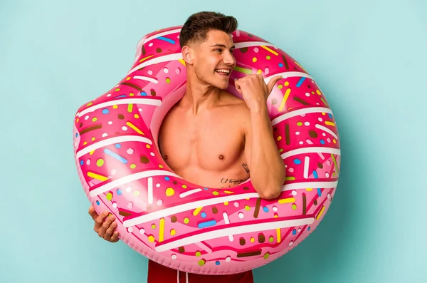Young Caucasian Man Holding Inflatable Donut Isolated Blue Background Points —  Fotos de Stock