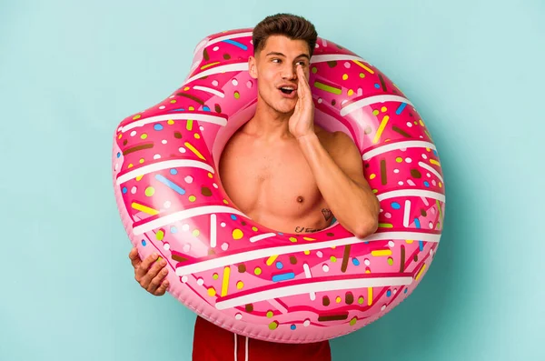 Young Caucasian Man Holding Inflatable Donut Isolated Blue Background Saying —  Fotos de Stock