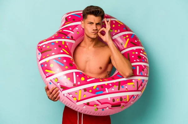 Young Caucasian Man Holding Inflatable Donut Isolated Blue Background Fingers —  Fotos de Stock