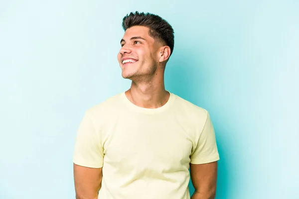 青の背景に隔離された若い白人男性リラックスして幸せな笑い 首は歯を示す伸展 — ストック写真