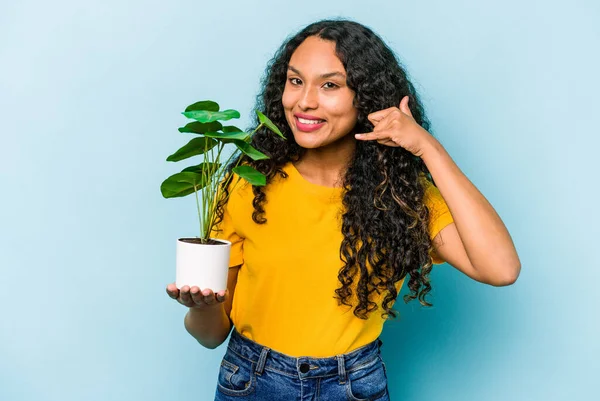 Young Hispanic Woman Holding Plant Isolated Blue Background Showing Mobile — Stock Photo, Image