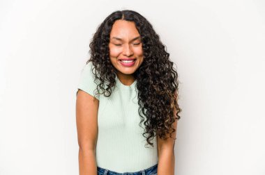 Beyaz arka planda izole edilmiş genç İspanyol kadın gülüyor ve gözlerini kapıyor, rahatlamış ve mutlu hissediyor..