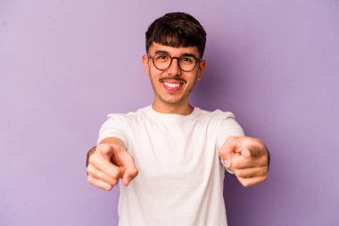 Mor arka planda izole edilmiş genç beyaz adam öne bakan neşeli gülücükler.