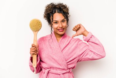 Beyaz arka planda izole edilmiş sırt kaşıyıcısı tutan genç İspanyol kadın gururlu ve kendinden emin hissediyor, örnek olarak..