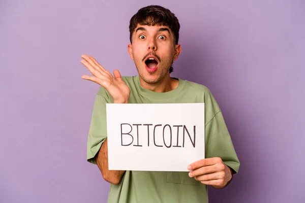Junger Hispanischer Mann Mit Bitcoin Plakat Auf Violettem Hintergrund Überrascht — Stockfoto