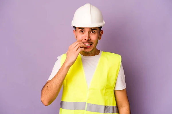 Young Hispanic Worker Man Isolated Purple Background Biting Fingernails Nervous — Stock Photo, Image