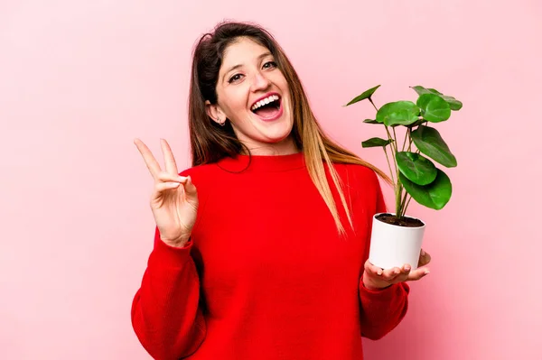 Young Caucasian Woman Holding Plant Isolated Pink Background Joyful Carefree — Stock Photo, Image