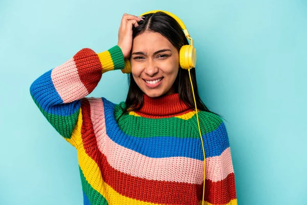 Young Hispanic Woman Listening Music Isolated Blue Background Being Shocked — Stock Photo, Image