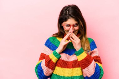 Kafkasyalı genç bir kadın pembe arka planda izole edilmiş bir plan yapıyor, bir fikir kuruyor..