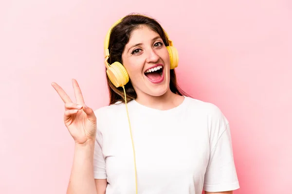 Young Caucasian Woman Listening Music Isolated Pink Background Joyful Carefree — Φωτογραφία Αρχείου