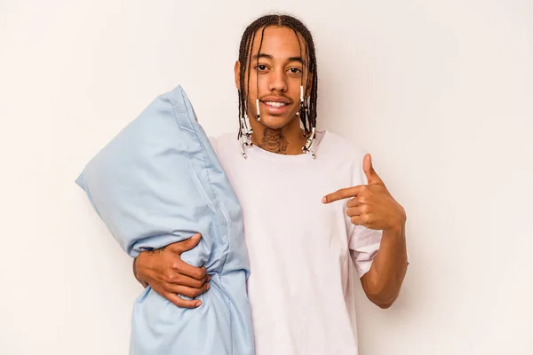 Young African American man wearing a pajama isolated on white background person pointing by hand to a shirt copy space, proud and confident