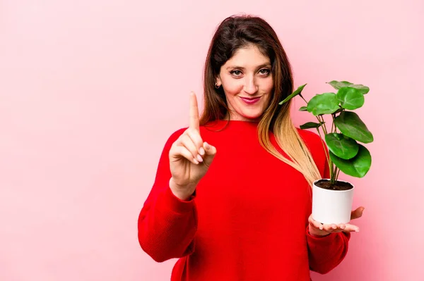 Young Caucasian Woman Holding Plant Isolated Pink Background Showing Number — Stock Photo, Image