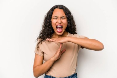 Young hispanic woman isolated on white background showing a timeout gesture.
