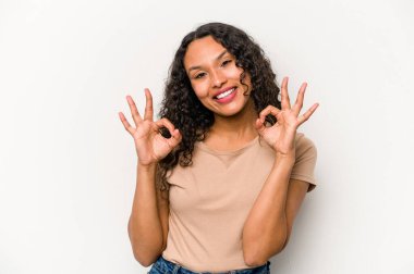 Young hispanic woman isolated on white background cheerful and confident showing ok gesture.