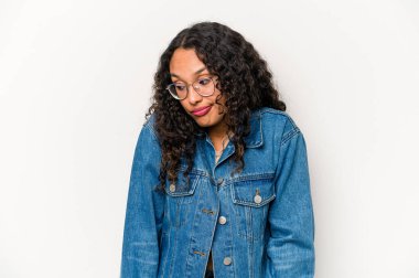 Young hispanic woman isolated on white background shrugs shoulders and open eyes confused.