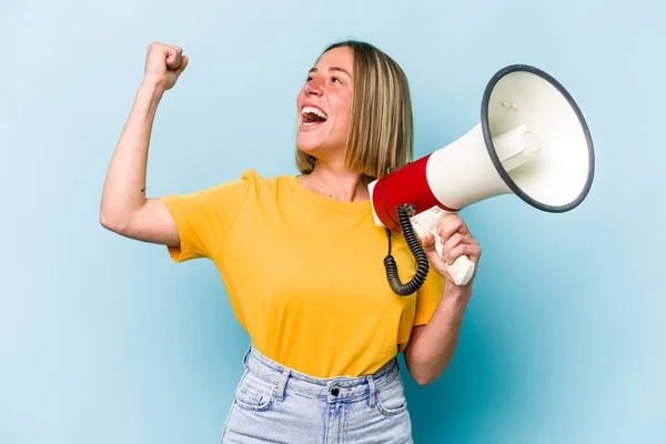 Young Caucasian Woman Holding Megaphone Isolated Blue Background Raising Fist — Stockfoto