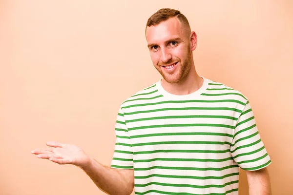 Young Caucasian Man Isolated Beige Background Showing Copy Space Palm — Stock Photo, Image