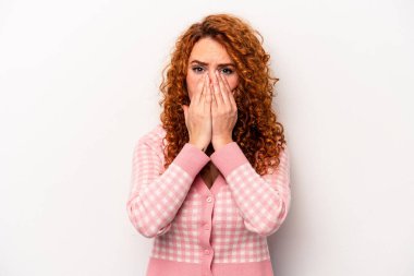Beyaz arka planda izole edilmiş, elleri endişeli bir şekilde ağzı kapalı, genç, beyaz bir beyaz kadın..