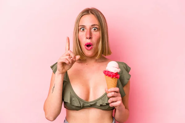 ビキニを着た若い白人女性とピンクの背景に隔離されたアイスクリームを保持するいくつかの素晴らしいアイデア 創造性の概念 — ストック写真
