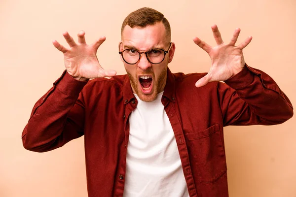 Young Caucasian Man Isolated Beige Background Showing Claws Imitating Cat — Stock Photo, Image