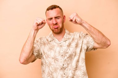 Beyaz tenli genç adam bej arka planda izole edilmiş sızlanıyor ve ağlıyordu..