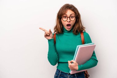 Young student caucasian woman isolated on white background pointing to the side