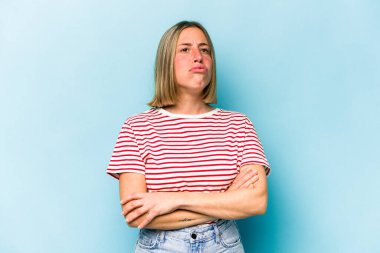 Mavi arka planda izole edilmiş genç beyaz kadın tekrarlanan bir görevden yoruldu..