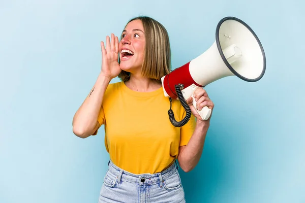 Young Caucasian Woman Holding Megaphone Isolated Blue Background Shouting Holding — Stockfoto