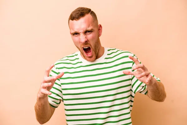 Young Caucasian Man Isolated Beige Background Screaming Rage — Stock Photo, Image