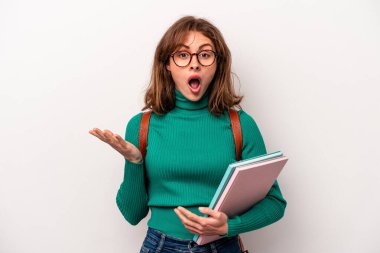 Young student caucasian woman isolated on white background surprised and shocked.