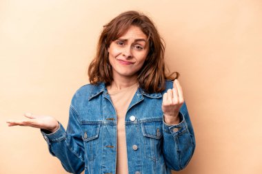 Beyazlı genç bir kadın bej arka planda izole edilmiş. Parası olmadığını gösteriyor..