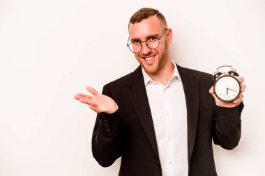 Beyaz arka planda, elinde alarm saati tutan genç beyaz bir adam bir avuç içinde fotokopi alanı ve belinde başka bir el tutuyor..