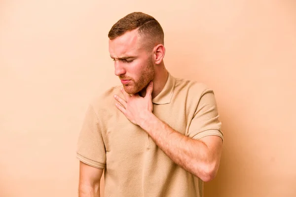 Young Caucasian Man Isolated Beige Background Suffers Pain Throat Due — Stock Photo, Image
