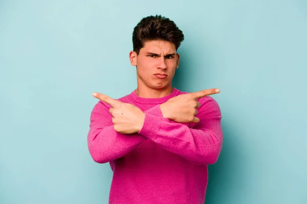Young Caucasian Man Isolated Blue Background Points Sideways Trying Choose — Stock Photo, Image