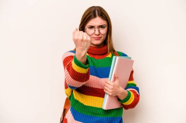 Young student caucasian woman isolated on white background showing fist to camera, aggressive facial expression.