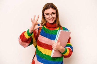 Young student caucasian woman isolated on white background cheerful and confident showing ok gesture.