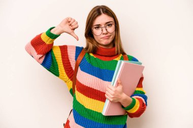 Young student caucasian woman isolated on white background showing a dislike gesture, thumbs down. Disagreement concept.
