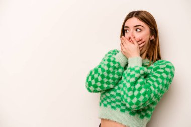 Beyaz arka planda izole edilmiş beyaz tenli genç bir kadın. Ağzını eliyle kapatan bir fotokopi odasına bakıyor..