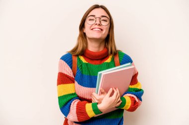 Young student caucasian woman isolated on white background laughing and having fun.