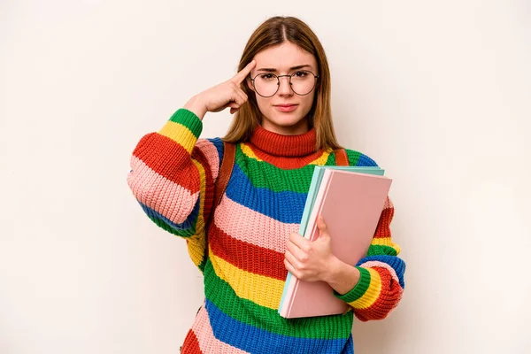 Young student caucasian woman isolated on white background pointing temple with finger, thinking, focused on a task.
