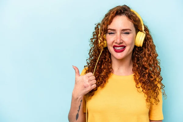 Young Ginger Woman Listening Music Isolated Blue Background Smiling Raising — Stock Photo, Image