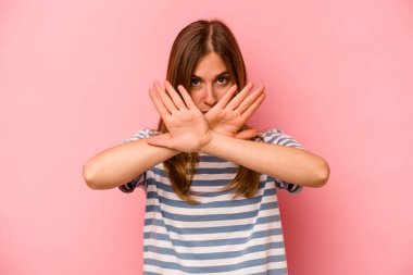 Pembe arka planda izole edilmiş beyaz bir kadın inkar jesti yapıyor.