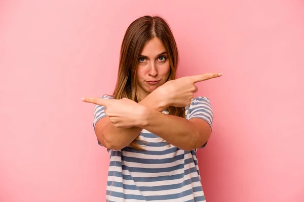 Young Caucasian Woman Isolated Pink Background Points Sideways Trying Choose — Stock Photo, Image