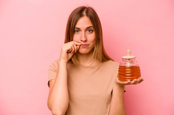 Young Caucasian Woman Holding Honey Isolated Pink Background Fingers Lips — Stock Photo, Image