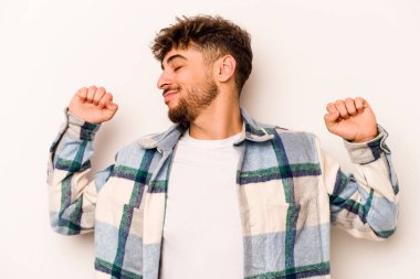 Beyaz arka planda izole edilmiş genç bir İspanyol. Kollarını uzatıyor, rahat duruyor..