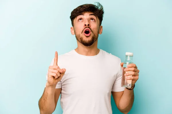 Young Hispanic Man Holding Bottle Water Isolated White Background Pointing — Stockfoto