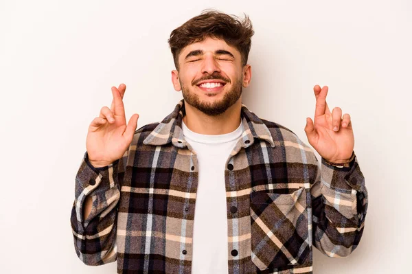 Young Hispanic Man Isolated White Background Crossing Fingers Having Luck — стоковое фото