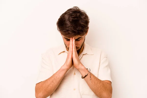 Young Hispanic Man Isolated White Background Praying Showing Devotion Religious — стоковое фото