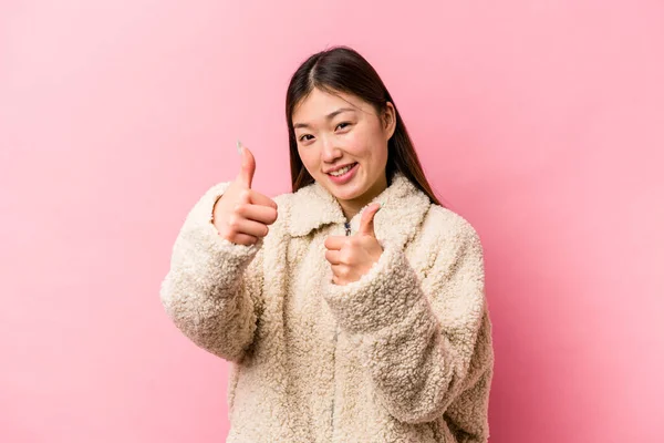 Mladá Číňanka Izolovaná Růžovém Pozadí Zvedá Oba Palce Nahoru Usmívá — Stock fotografie