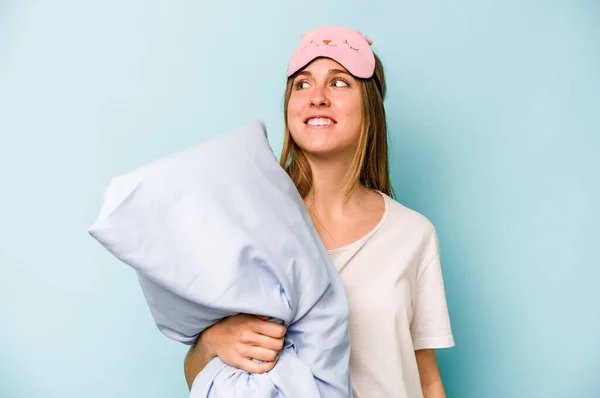 Young Caucasian Woman Wearing Pajama Isolated Blue Background Looks Aside — Stock Photo, Image